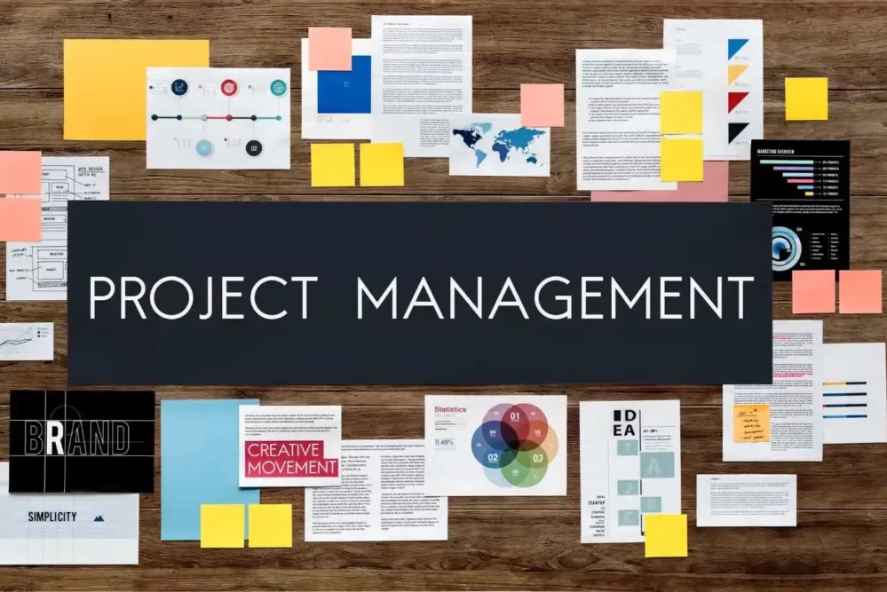 a wall with several papers pasted and the writing project management on top