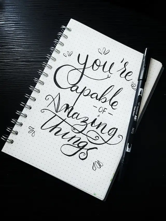 a notebook written "you're capable of amazing things"