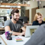 3 young people sharing a workspace