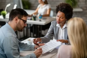 recruitment agencies: a woman talking to a man at an office desk