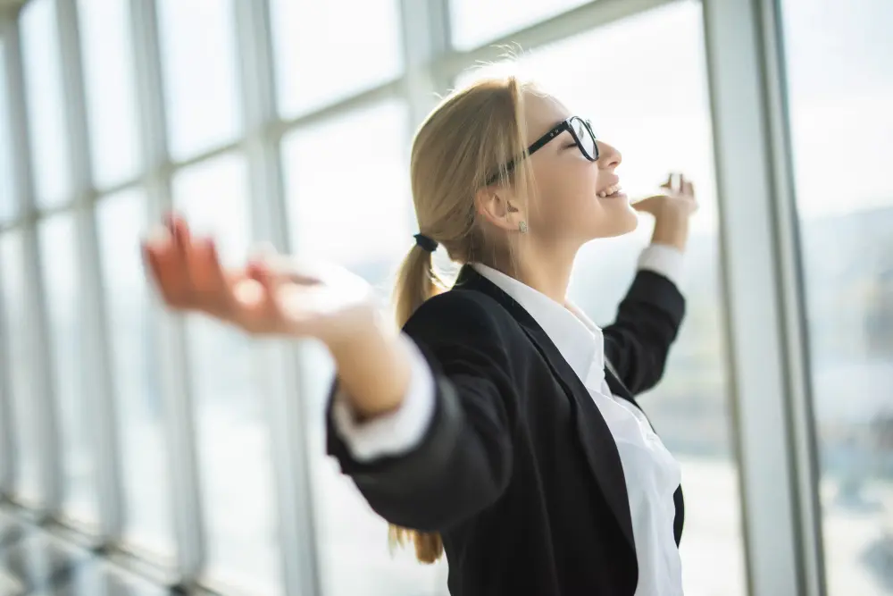 increase thinking capacity: a woman facing a window with open arms and happy
